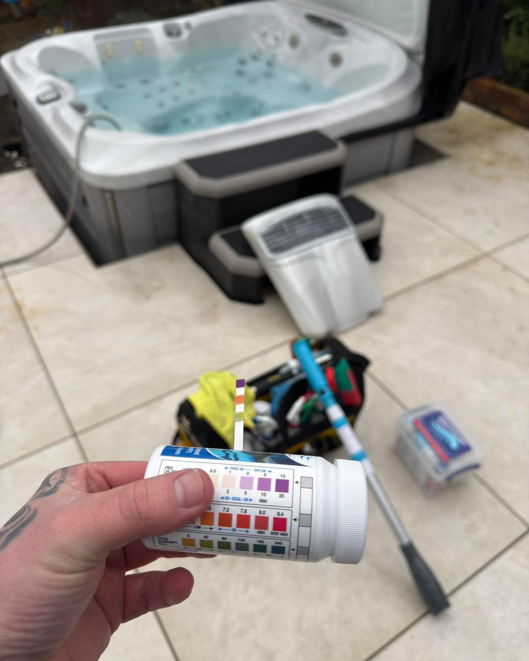 Technician performing a professional water chemistry test during a hot tub service in Southport.